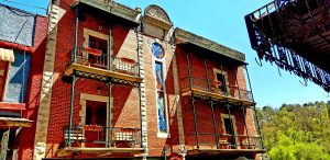 A vibrant red brick building with balconies in Eureka Springs, Arkansas.