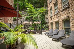 Relaxing outdoor patio with lounge chairs and lush greenery in Eureka Springs, Arkansas.