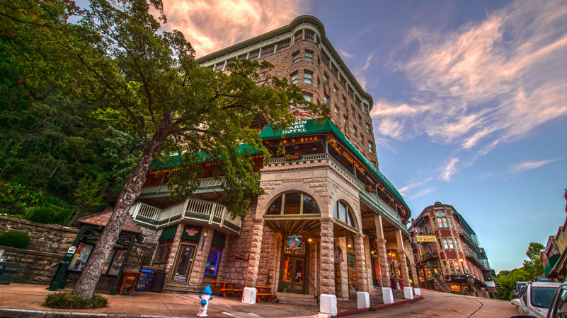 Sunset street view of historic Downtown Eureka Springs Basin Park Hotel