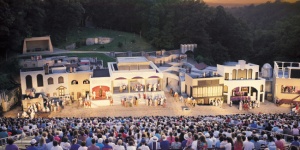 A lively outdoor theater performance with an audience in Eureka Springs, Arkansas.
