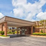 Travel Eureka Springs welcome center with brick facade and lush landscaping.