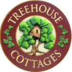Treehouse cottage nestled among lush green trees in Eureka Springs, Arkansas.