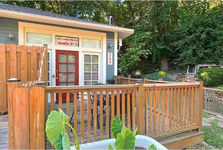 Charming outdoor deck with lush greenery in Eureka Springs, Arkansas.